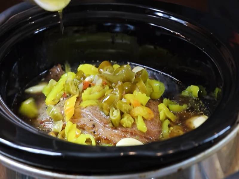 Best Homemade Slow Cooker Italian Beef Sandwich add roast in the pot as seen in SlowCookerSociety.com